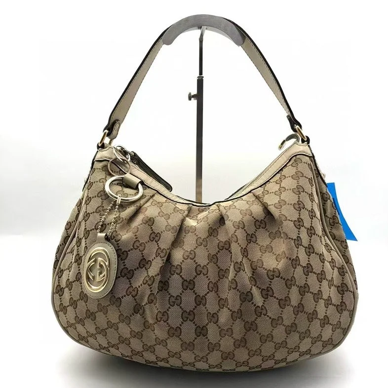 Gucci Marmont bags for women with gold - toned hardwareGucci Beige Monogram Canvas Shoulder Bag Medium